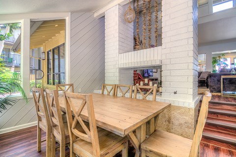 a dining room with a wooden table and chairs